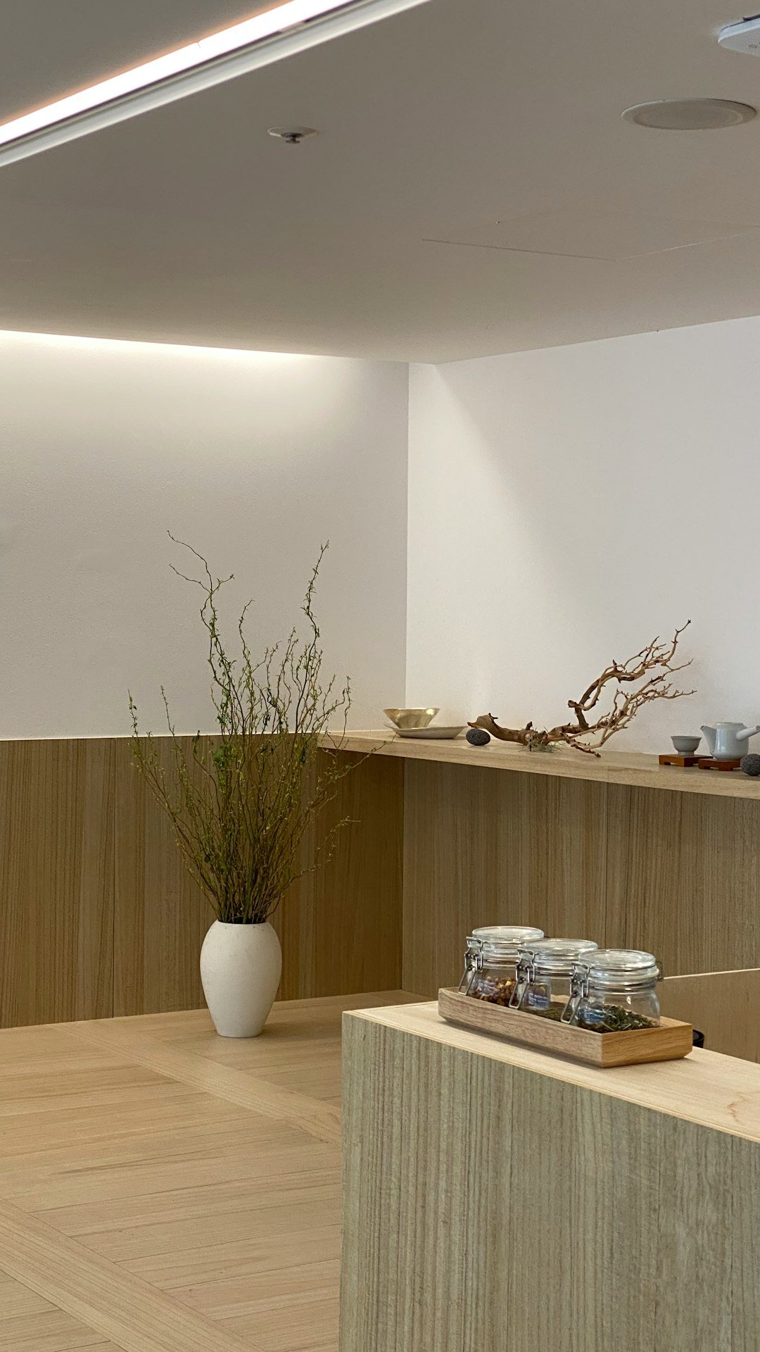 Close-up of natural oak wood and travertine stone material details in a minimalist interior